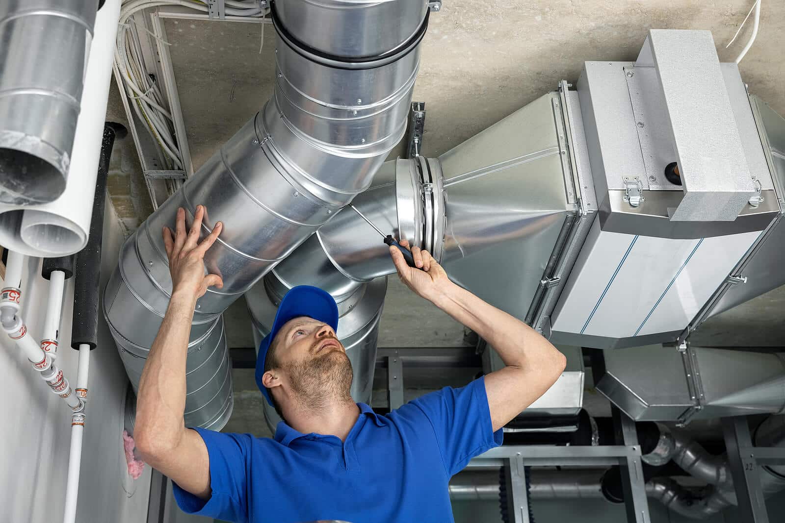 HVAC technician inspecting and repairing air ducts in San Lorenzo