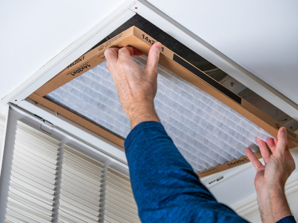 HVAC technician replacing a home air filter in San Lorenzo