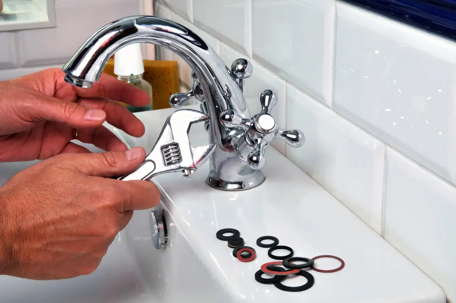 Plumber maintaining a bathroom faucet in San Lorenzo