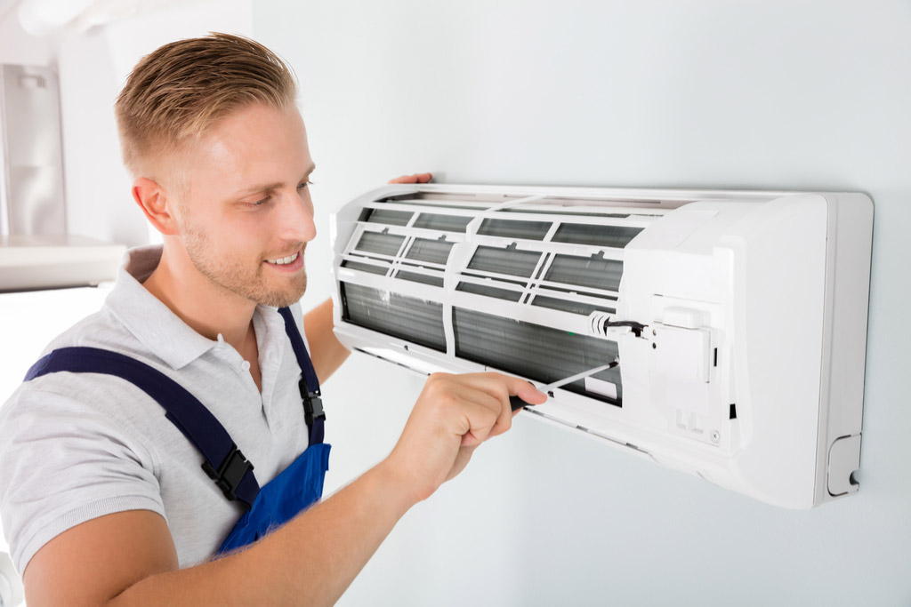HVAC technician maintaining a ductless air conditioner in San Lorenzo