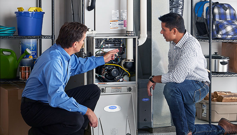 Technician evaluating a furnace for repair or replacement in San Lorenzo