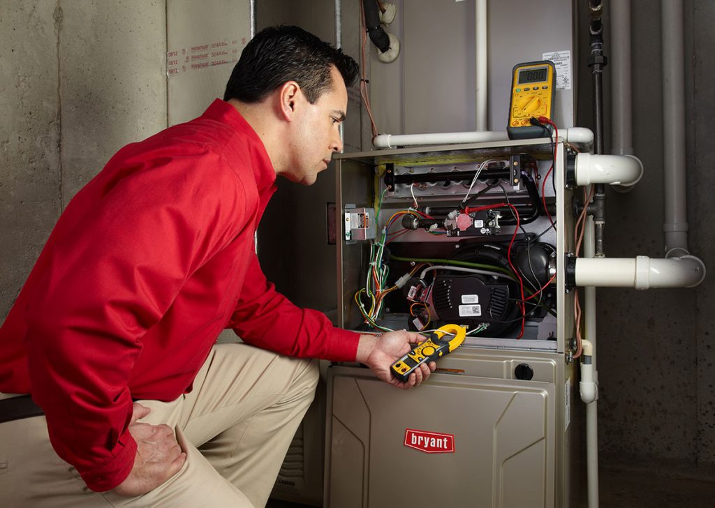 Heating technician diagnosing a furnace repair in San Lorenzo