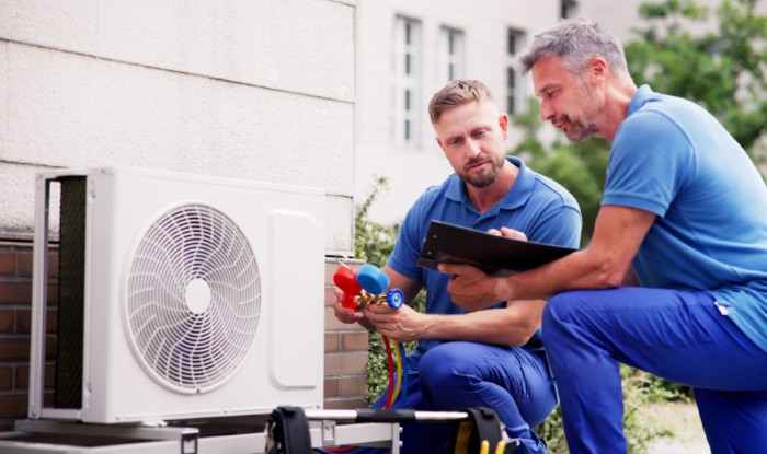 HVAC technicians installing an outdoor air conditioning unit in San Lorenzo