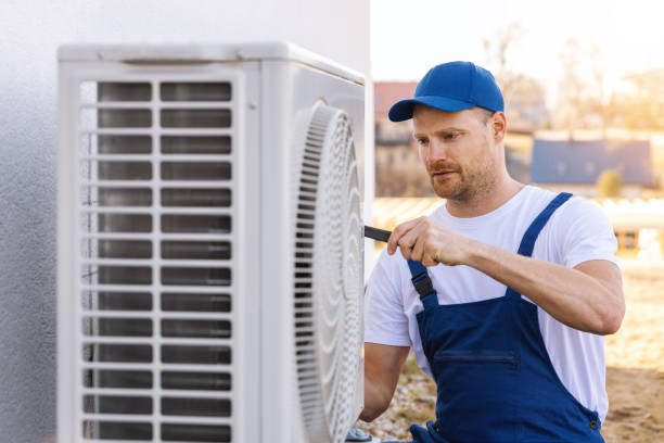 HVAC technician servicing an outdoor air conditioner in San Lorenzo
